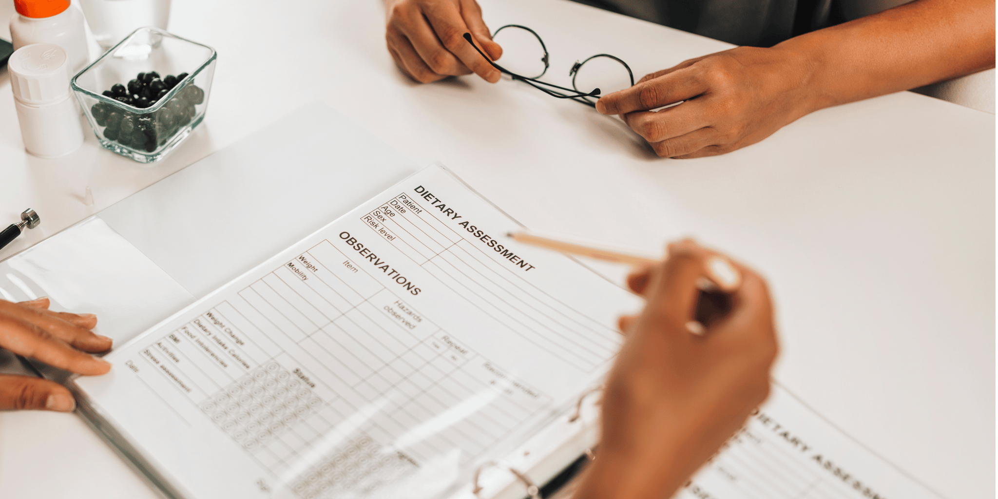 Image showing an overhead view of a person marking a dietary assessment sheet for a GLP-1 weight loss programme