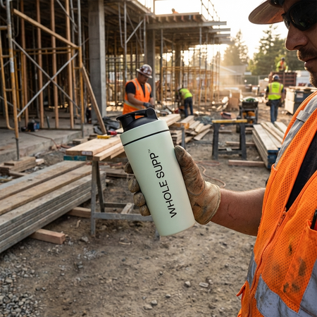 Person holding a 'Whole Supp' shaker at a construction site